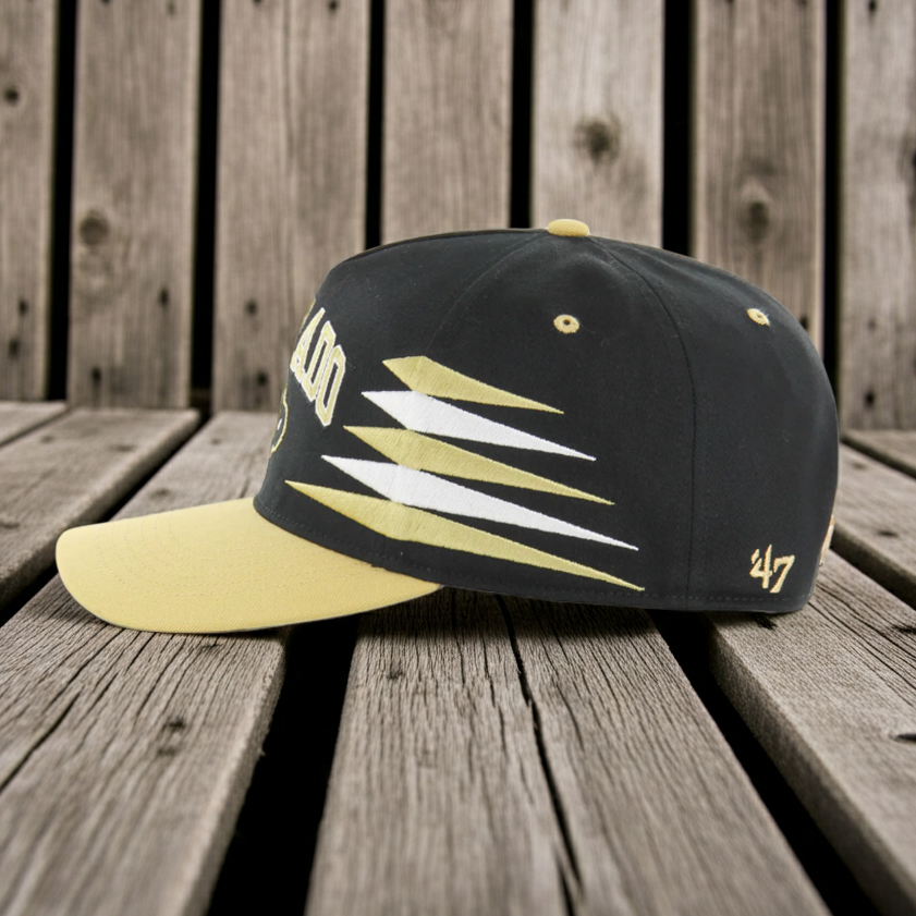 Black and yellow Colorado Buffaloes cap with '47' logo on a wooden surface