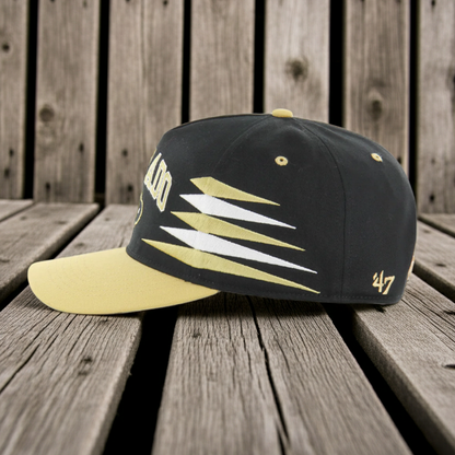 Black and yellow Colorado Buffaloes cap with '47' logo on a wooden surface